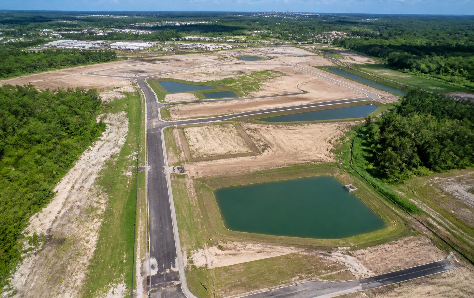 Aerial view of development site showing drainage ponds and roads